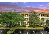 Inviting exterior featuring multi-level balconies, manicured landscaping, and convenient parking at 510 Rum Run # 33 510, Davenport, FL 33837