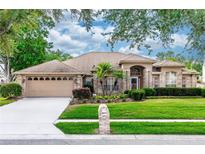 Charming single-story brick home with a well-manicured lawn and mature landscaping, offering great curb appeal at 603 Yorkshire Dr, Oviedo, FL 32765
