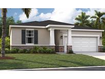 Charming single-story home featuring a two-car garage, stone accents, and a well-manicured lawn at 894 Pebble Crest Ln, Eagle Lake, FL 33839