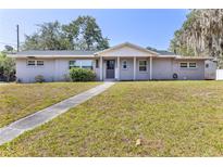Charming single-story home with a well-maintained lawn and inviting front porch at 1101 Mizell Rd, Leesburg, FL 34748