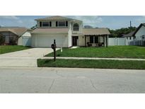 Charming two-story home featuring a well-manicured lawn and inviting front porch area at 1668 Spicewood Ln, Casselberry, FL 32707