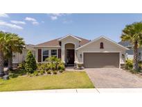 Charming one-story home with a two-car garage, beautiful landscaping and a brick paved driveway at 2126 Ridge Pointe Ln, Clermont, FL 34715