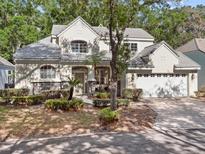 Charming two-story home featuring stone accents, a well-manicured lawn, and a two-car garage at 220 Wimbledon Cir, Lake Mary, FL 32746