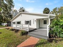 Charming single-story home with a welcoming front porch and well-maintained landscaping at 2205 Pine Island Dr, New Smyrna Beach, FL 32168