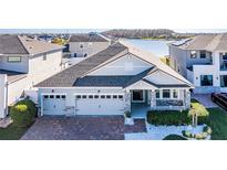 Charming single-Gathering home with a brick driveway, a three-car garage, and a well-maintained front yard at 2417 Annacella Ave, Kissimmee, FL 34741