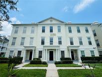 Attractive two-story townhouse featuring a symmetrical facade, manicured lawn, and inviting entrance at 276 Celebration Blvd, Celebration, FL 34747