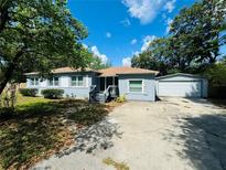 Charming single story home featuring a detached garage and mature shade trees at 412 Editha Cir, Sanford, FL 32771