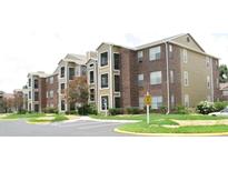 Well maintained apartment complex exterior with parking at 4225 Thornbriar Ln # 305, Orlando, FL 32822