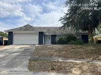 Charming single-story home featuring an attached garage and a cozy front yard in a suburban setting at 7614 Brisbane Ct, Orlando, FL 32835