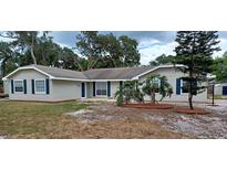 Charming single-story home featuring neutral siding, dark shutters, manicured landscaping and a well-maintained lawn at 131 Lake Charles Rd, Deland, FL 32724