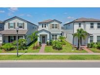 Charming two-story home with a well-manicured lawn and tropical landscaping at 13748 Werrington Dr, Winter Garden, FL 34787