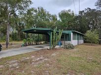 Charming single-story home featuring a covered carport and desert landscaping at 1424 Lake Shore Dr, Casselberry, FL 32707