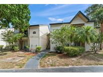 Inviting two-story condo with well-maintained landscaping and exterior features under a sunny sky at 1956 Lake Atriums Cir # 146, Orlando, FL 32839