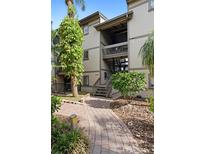 Charming condo building featuring a brick walkway surrounded by lush landscaping at 652 Lake Villas Dr # D, Altamonte Springs, FL 32701