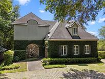 Unique exterior elevation with stone accents, ivy-covered walls, and mature landscaping at 996 Fairview Ave, Mount Dora, FL 32757