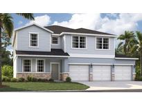 Charming two-story home with light blue siding, stone accents, and a three-car garage at 1339 Wood Line Dr, Deland, FL 32720