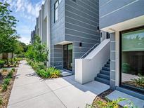 Modern townhome exterior showcasing sleek architecture, landscaping, and a welcoming entrance at 1764 Mondrian Cir, Winter Park, FL 32789