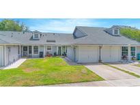Inviting townhome showcasing well-maintained lawn and a two car garage for comfortable suburban living at 4541 Southfield Ave, Orlando, FL 32812