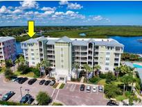 Waterfront condo building with multiple stories, well-kept grounds, and ample parking for residents and guests at 5 Riverwalk Dr # 601, New Smyrna Beach, FL 32169