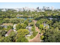 Stunning aerial view of the neighborhood, showcasing its lush greenery, lake and proximity to downtown Orlando at 100 Kennison Dr, Orlando, FL 32801