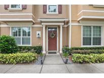 Charming home entrance with a lovely wreath and well-maintained landscaping at 1062 Winglewood, Altamonte Springs, FL 32714