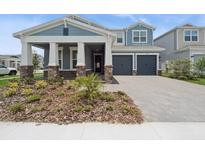 Charming two-story home with a two-car garage, beautiful stone accents, and a well-manicured front yard at 13187 Telsen St # 38, Winter Garden, FL 34787