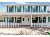 Charming two-story home with green shutters and inviting front porch, perfect for enjoying the outdoors at 2320 Red Ember Rd, Oviedo, FL 32765