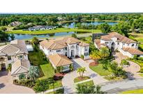 Stunning lakefront property showcasing a luxurious estate with a grand entrance and meticulously landscaped grounds at 4065 Isabella Cir, Windermere, FL 34786