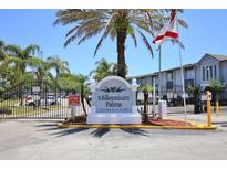 Millennium Palms Condominiums entrance sign with palm trees under blue sky at 4727 S Texas Ave # 4727C, Orlando, FL 32839
