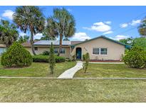 Charming single-story home with well-manicured lawn, desert landscaping, and inviting entrance at 820 Hobson St, Longwood, FL 32750