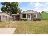 Charming single-story home featuring a well-maintained lawn, cozy covered porch, and neutral exterior paint at 1010 Timor Ave, Orlando, FL 32804