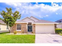 Charming single-story home with stone accents, manicured lawn, and a two-car garage at 113 Venetian Bay Cir, Sanford, FL 32771