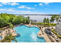 Enjoy access to this large in-ground community pool with views of the lake and walking pier at 13415 Blue Heron Beach Dr # 409, Orlando, FL 32821