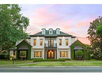 Elegant two-story home featuring lush landscaping and a classic architectural design at 141 S Phelps Ave, Winter Park, FL 32789