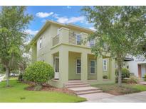 Two-story home featuring a second-story balcony and an inviting brick staircase at 14244 Walcott Ave, Orlando, FL 32827