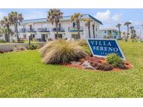 Beautiful condo building with ocean views and lush landscaping; signage reads Villa Sereno at 2750 Ocean Shore Blvd # 350, Ormond Beach, FL 32176