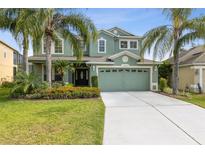 Inviting two-story home with a well-manicured lawn, lush landscaping, and a spacious two-car garage at 2842 Balforn Tower, Winter Garden, FL 34787