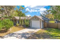 Charming single-story home with attached garage and well-manicured lawn at 2927 Ahern Dr, Orlando, FL 32817