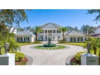 Stunning two-story home with a circular driveway, water fountain, and meticulous landscaping at 6139 Greatwater Dr, Windermere, FL 34786
