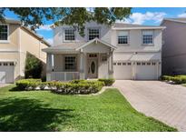 Charming two-story home with well-manicured lawn, covered porch, and a convenient two-car garage at 10097 Lake District Ln, Orlando, FL 32832