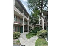 Condominium building exterior with landscaping and balconies, featuring multiple units and a walkway at 109 Oyster Bay Cir # 120, Altamonte Springs, FL 32701