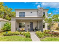 Charming two-story home with a stone accent chimney, inviting front porch, and well-manicured landscaping at 1127 W Harvard St, Orlando, FL 32804