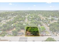 Aerial view of a charming home with mature trees and landscaping, close to amenities at 2312 Corrine Dr, Orlando, FL 32803