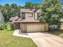 Charming two-story home featuring a well-maintained lawn, brick accents, and an attached two-car garage at 2706 Donaldson Dr, Orlando, FL 32812