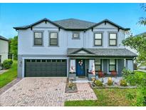 Charming two-story home with a brick-paved driveway, attached garage, and cozy front porch at 2926 Boating Blvd, Kissimmee, FL 34746