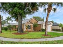 Charming single-story home with a two-car garage and well-manicured lawn with mature trees at 311 Lakebreeze Cir, Lake Mary, FL 32746