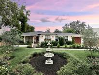 Charming home features a beautifully landscaped front yard with a decorative fountain at 446 Piney Croft Ln, Maitland, FL 32751