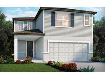 Charming two-story home features a two-car garage, well-maintained landscaping, and a covered front porch entrance at 4997 Kaia Ave, Winter Haven, FL 33884