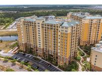 Luxury condo buildings with balconies, lush landscaping, and convenient parking at 8101 Resort Village Dr # 31501, Orlando, FL 32821