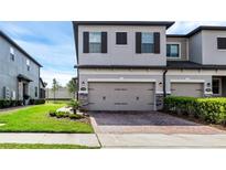 Charming two-story townhome with a two-car garage and brick-paved driveway at 11968 Sands Cv, Orlando, FL 32828